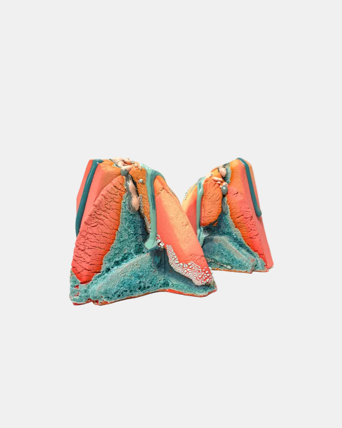 Two sculptural, textured mountain-like wall art pieces in coral orange, teal, and turquoise, displayed against a solid white background.