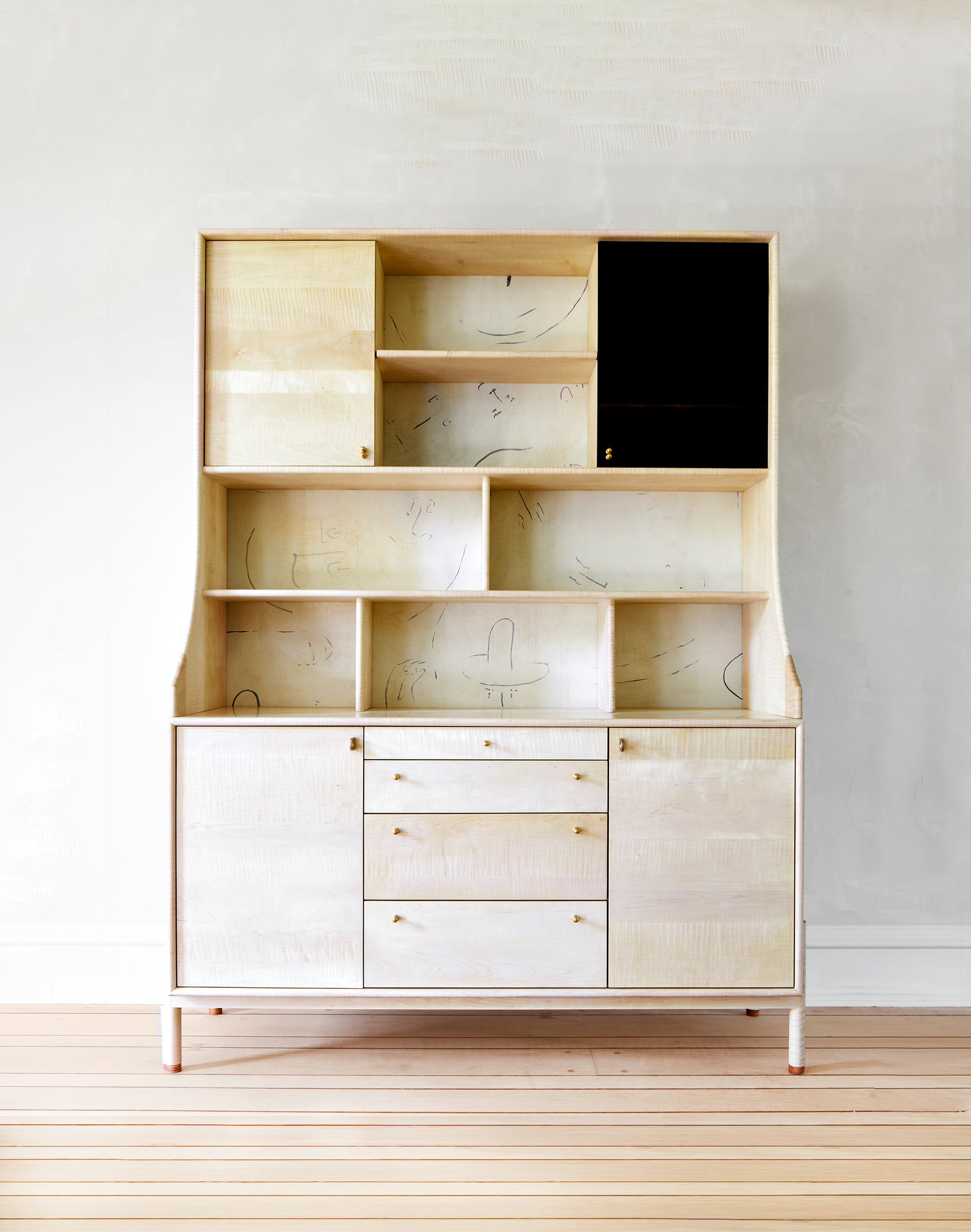 Wooden cabinet with open shelves and closed doors on a wooden floor.